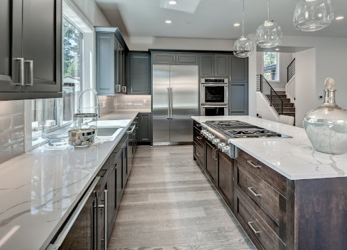 Modern kitchen remodel with sleek dark cabinetry and marble countertops